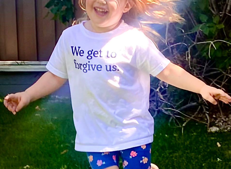 We get to forgive us.™ (toddler white tee)